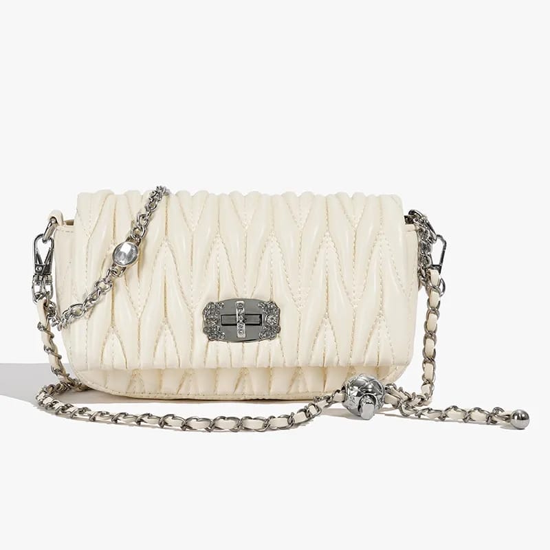 Front view of the TRENDBUY cream white quilted sling bag, showcasing its unique texture, silver-tone chain, and crystal-studded clasp.