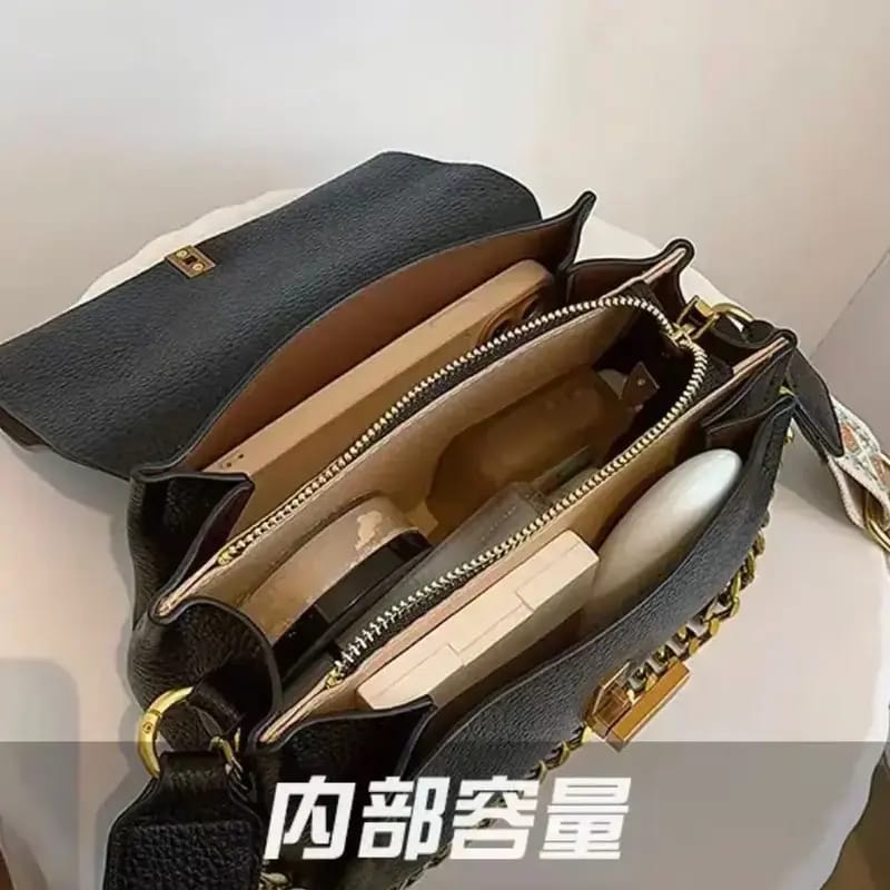 Detailed interior view of the black TRENDBUY sling bag, revealing multiple organized compartments and a secure zipper pocket.