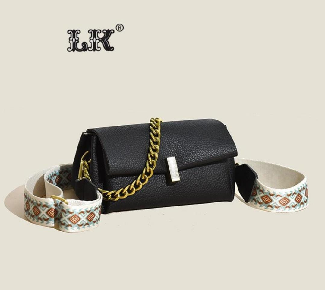 Black TRENDBUY sling bag with the 'LK®' logo, highlighting its structure and the stylish broad patterned strap detached.