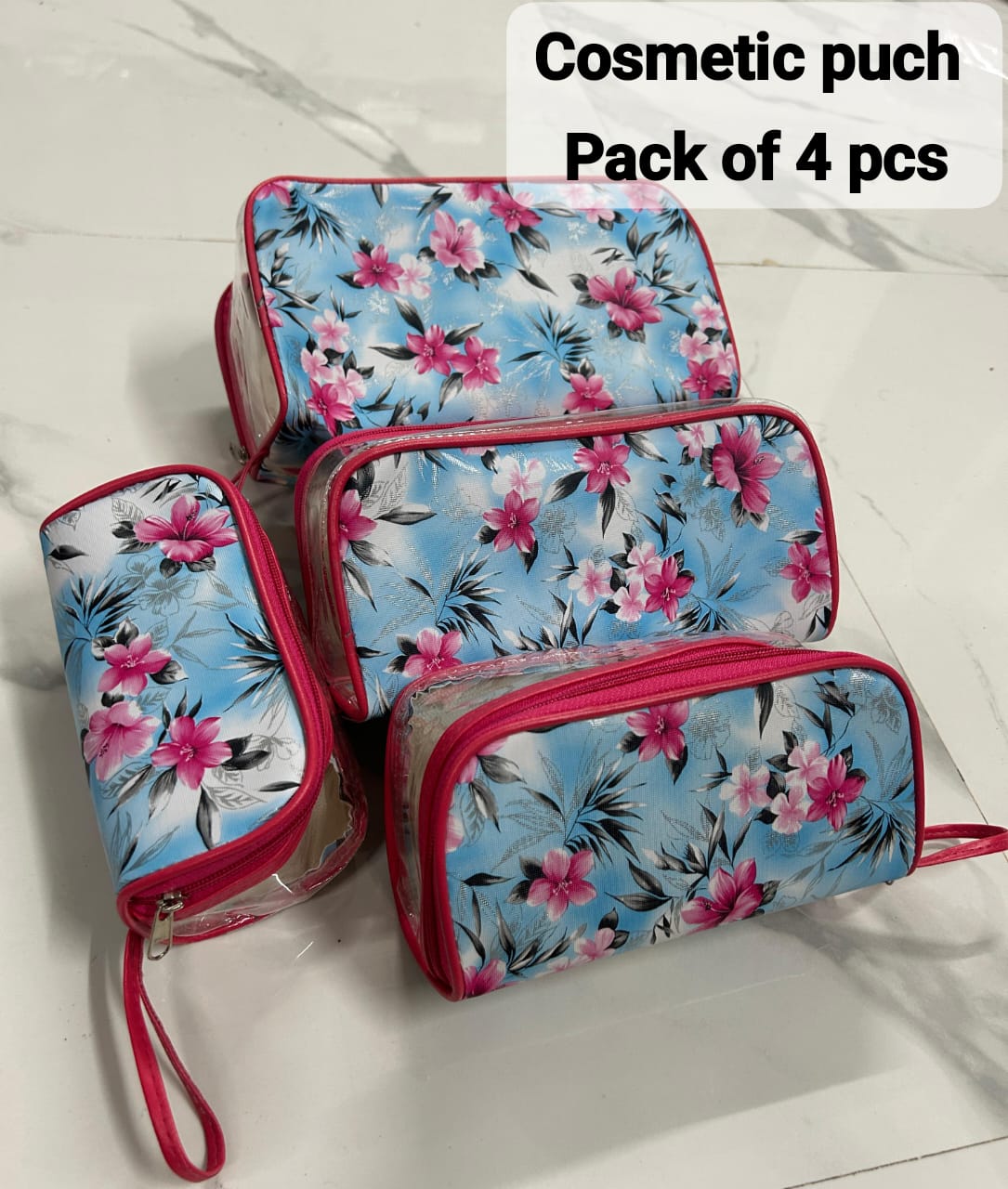 TRENDBUY 4-piece transparent travel organizer set with blue floral print and hot pink trim.