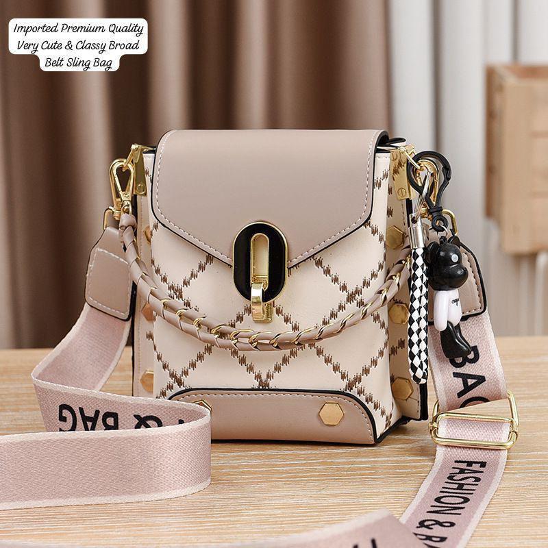 Front view of the TRENDBUY beige and white broad belt sling bag, highlighting its gold hardware, checkered pattern, and broad 'FASHION BAG' strap.