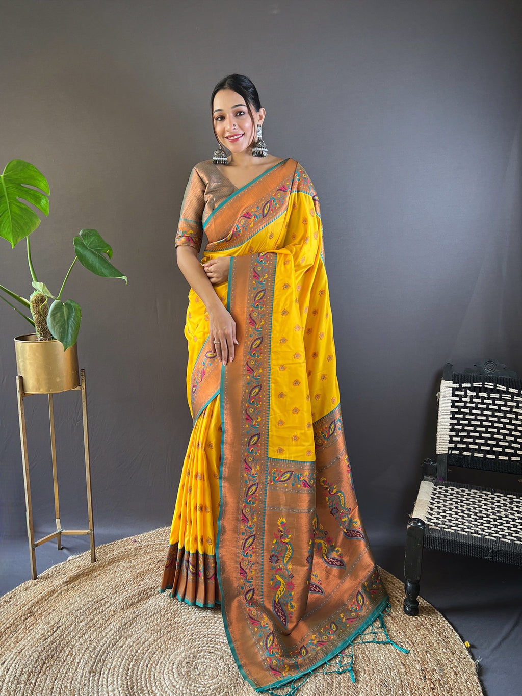 Yellow silk Paithani Kanjivaram saree, richly woven with traditional designs.