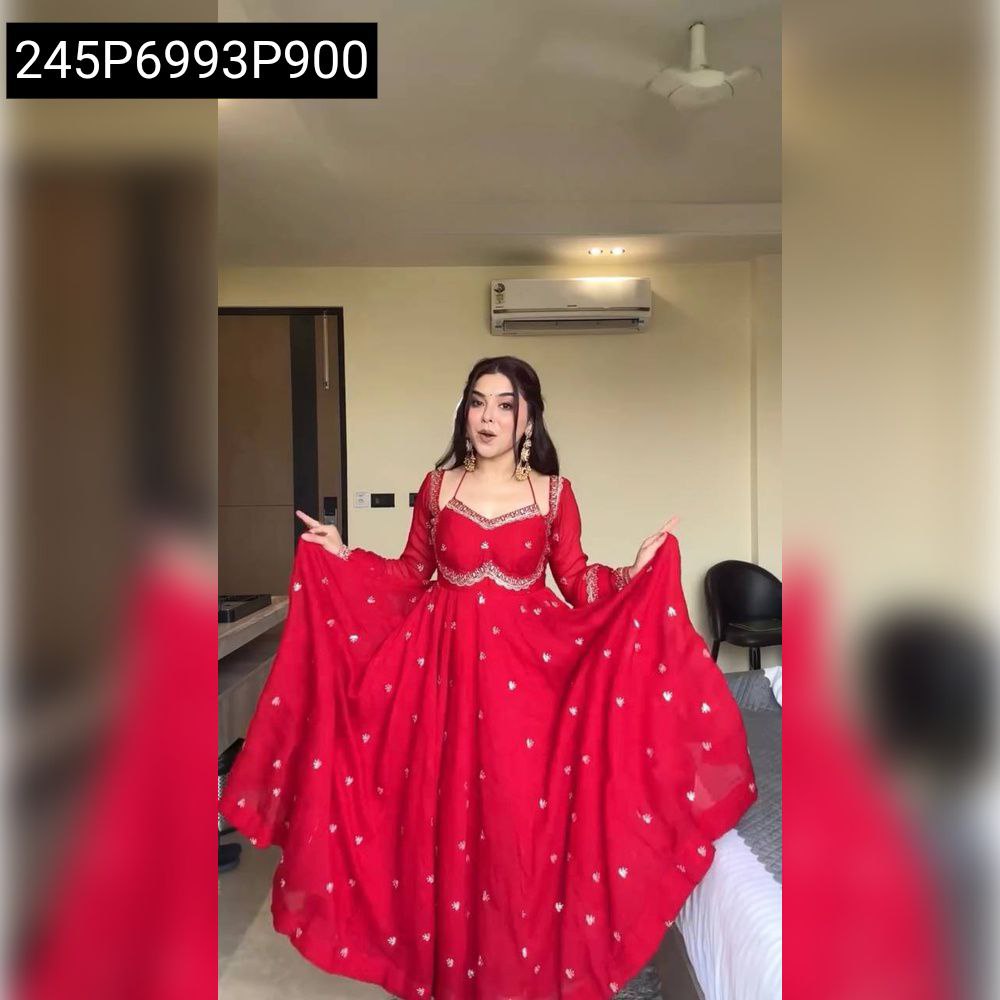 Model posing dynamically in a red Anarkali suit with gold sequence work, showcasing the full flair.