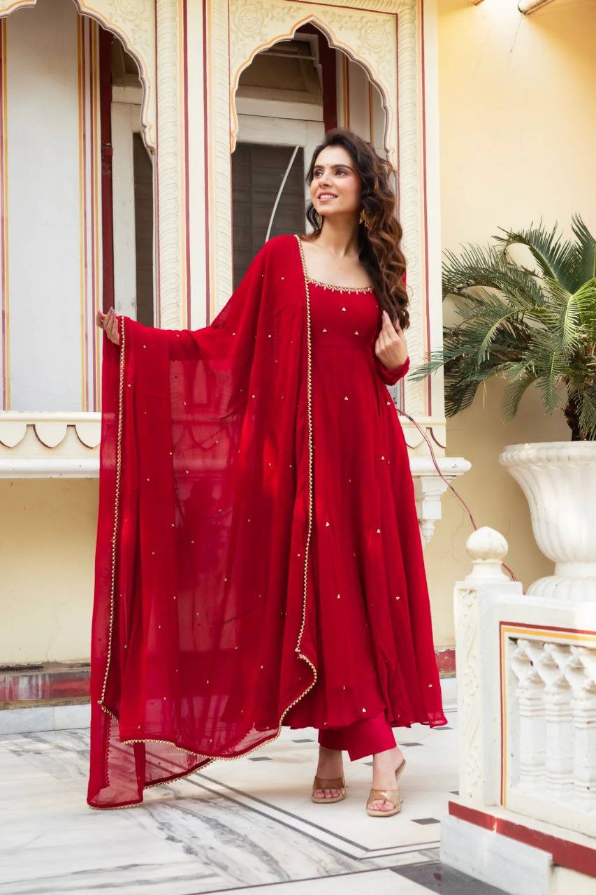 Model wearing a red Georgette Anarkali kurta set with dupatta, elegant pose.