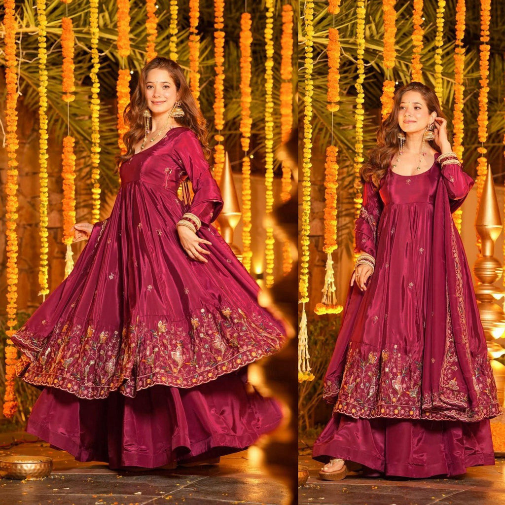 TRENDBUY Designer Anarkali Suit in Maroon, woman posing showing flair and embroidery, festive backdrop