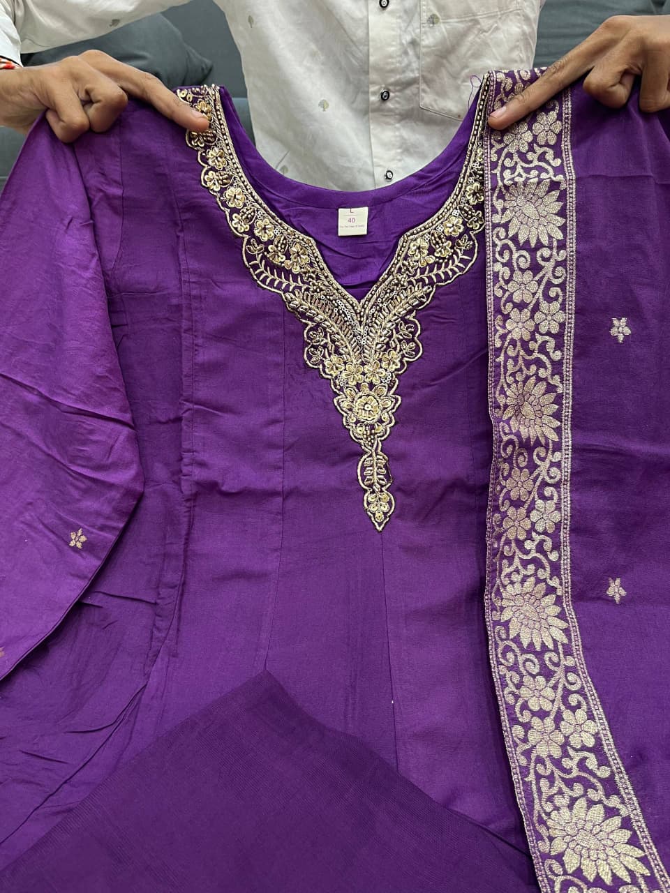 TRENDBUY Premium Chanderi Anarkali Suit in rich Lavender Purple, featuring an ornate gold hand-worked neckline and elegant Banarasi zari weaving on the flare and dupatta, perfect for festive wear.