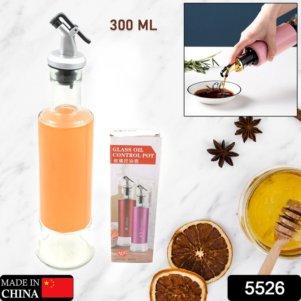 Hand pouring olive oil from a 300ml leakproof dispenser bottle with a non-drip spout for kitchen cooking.
