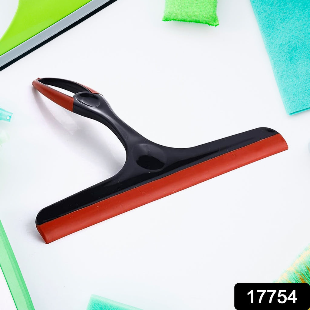 Multicolor plastic kitchen wiper with silicone head effectively cleaning a wet kitchen platform.