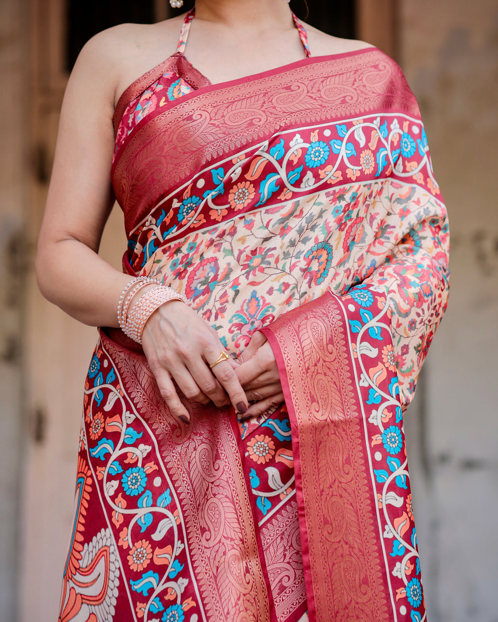 Close-up of a woman's torso, highlighting the intricate digital print and rich zari border of the Banarasi silk saree and matching blouse.