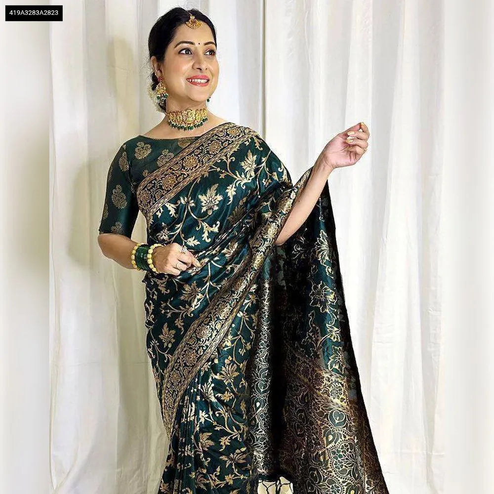 Woman in dark green Banarasi Soft Lichi Silk Saree with rich gold jacquard work, front view.
