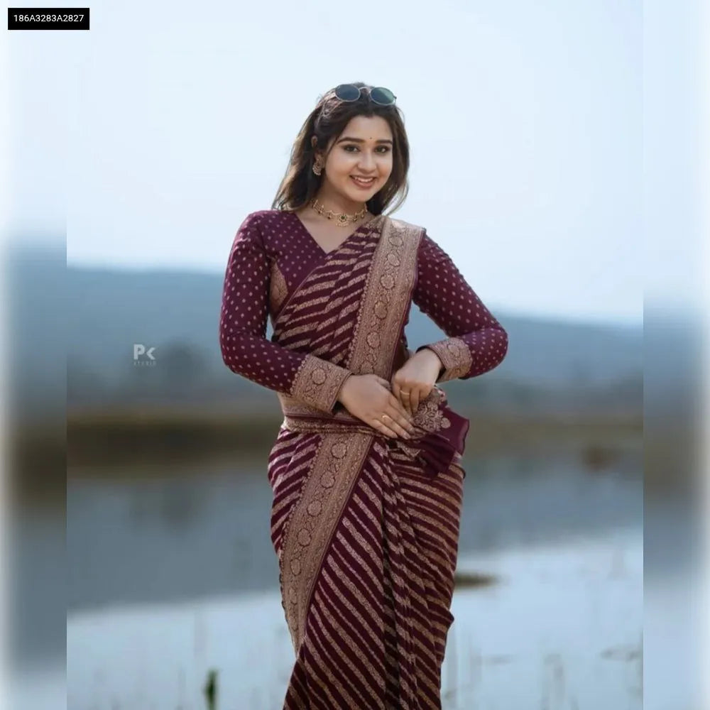 Model smiling, wearing TRENDBUY Banarasi Soft Silk Saree in Maroon Gold, 3/4 front view