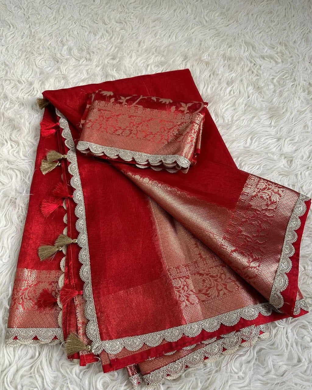 TRENDBUY Red Banarasi Tissue Silk Saree with golden lace border, tassels, and matching Jaal weaving blouse piece, folded on white background.