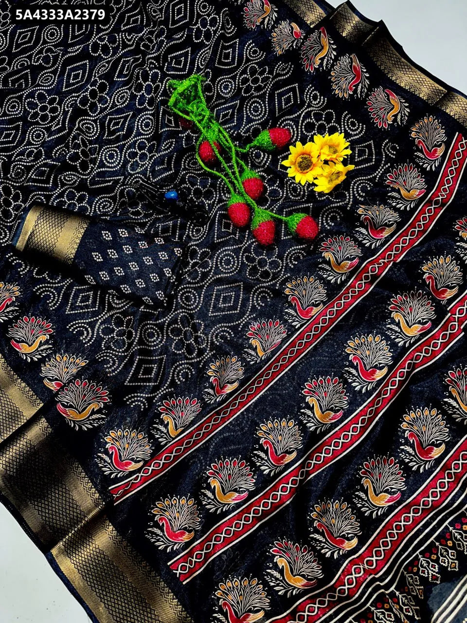 Black Bandhani Dola Silk Saree with peacock motifs and gold border.