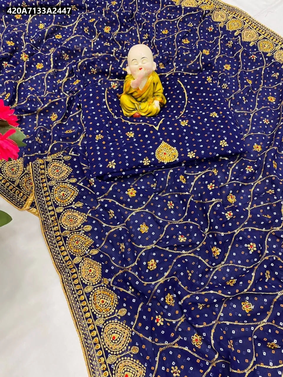 TRENDBUY Bandhani Georgette Saree in Royal Blue with heavy embroidery and stone work, flat lay