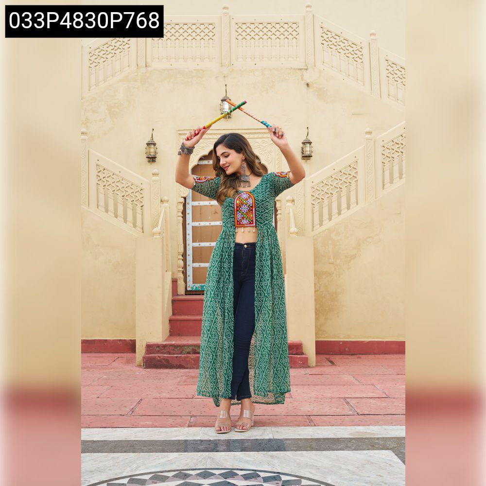 Model posing with dandiya sticks in a vibrant green Bandhani print georgette kurti, showcasing its full length and unique design.