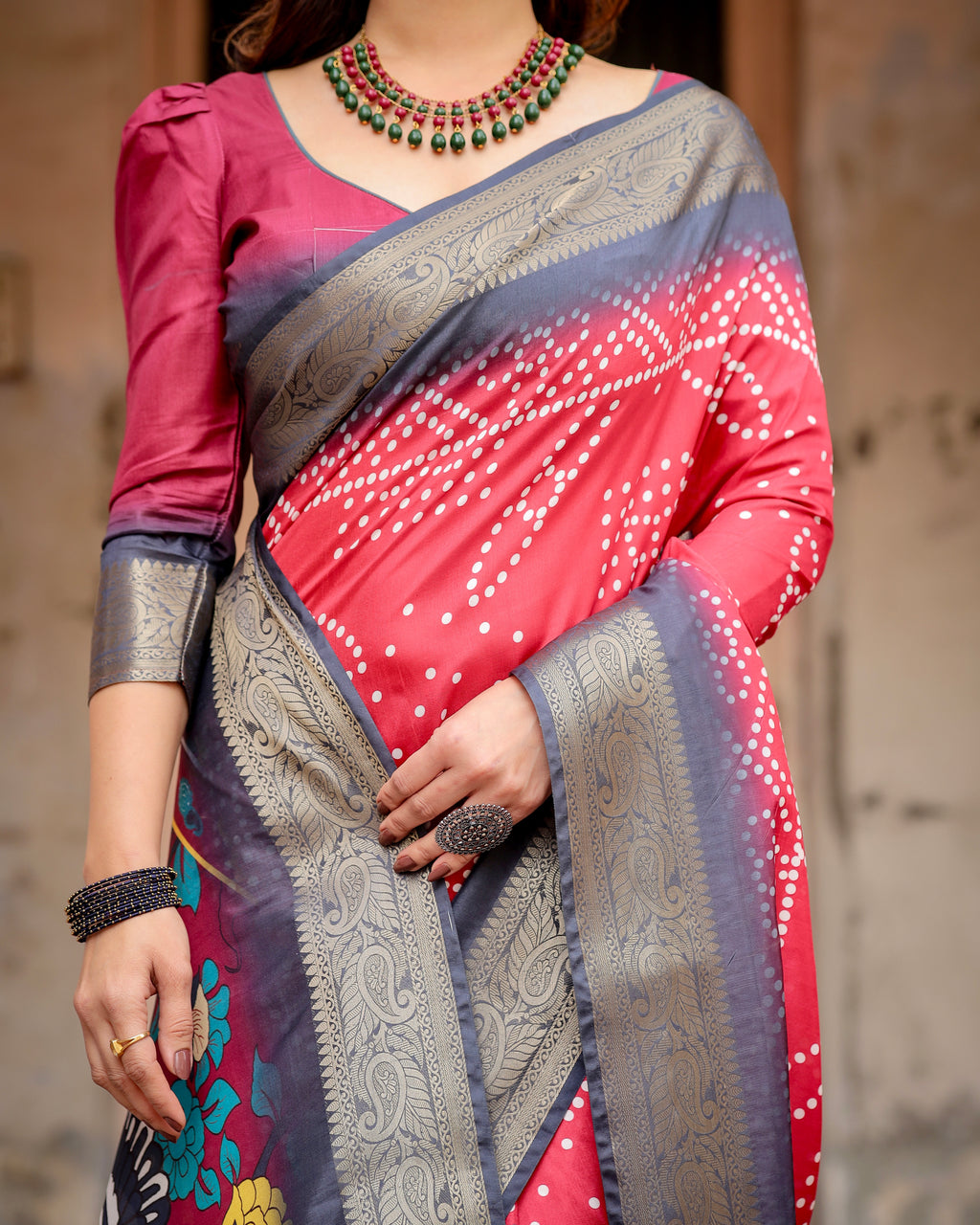Close-up of model in Bandhani-style Tussar silk saree, highlighting the wine red bandhani print, rich navy and silver zari border, and intricate pallu.