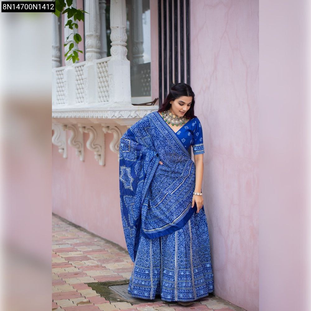 Model wearing TRENDBUY Royal Blue Bandhani Vaishali Silk Lehenga Choli with Gota Patti, standing against a pink wall.
