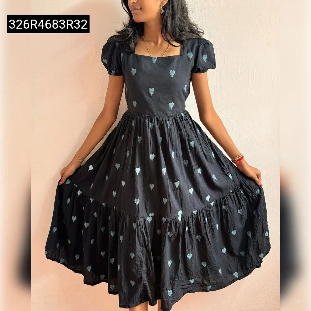 Young woman wearing TRENDBUY Black Maska Cotton Maxi Dress with Teal Heart Embroidery, full body front view against white wall