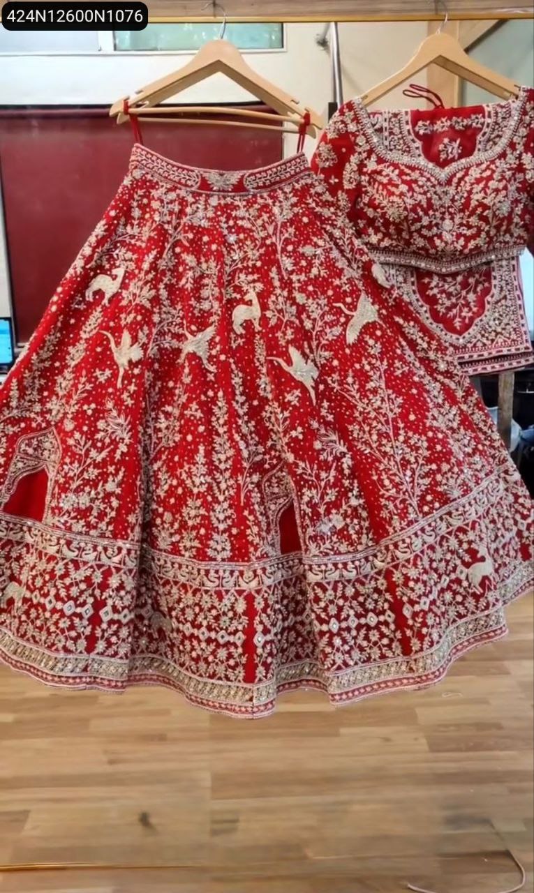 TRENDBUY Bridal Heavy Embroidery Mirror Work Lehenga Choli in Red, front view on hanger