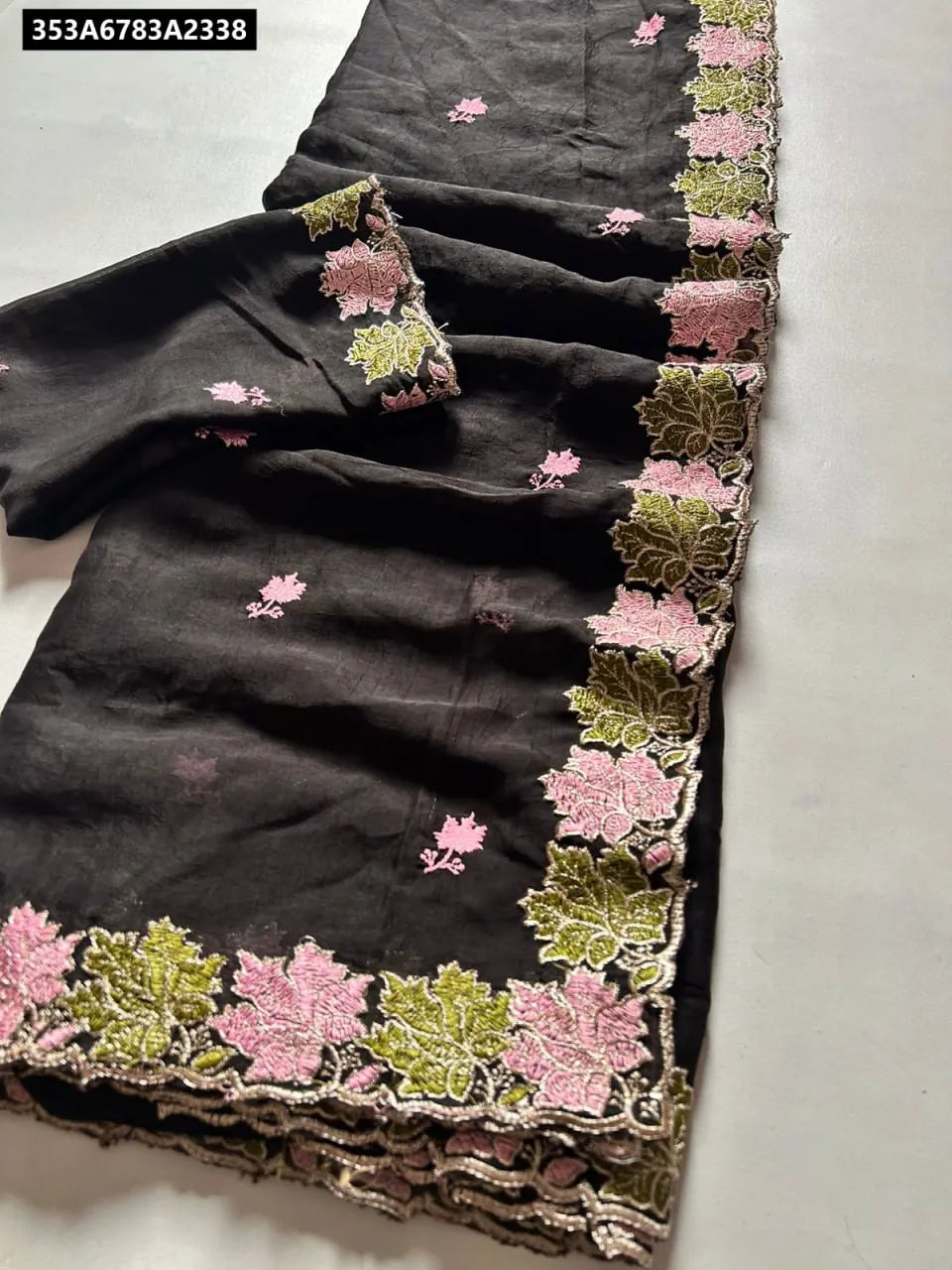 TRENDBUY Black Rangoli Crush Silk Saree with pink and green floral embroidery and cutwork border, flat lay.