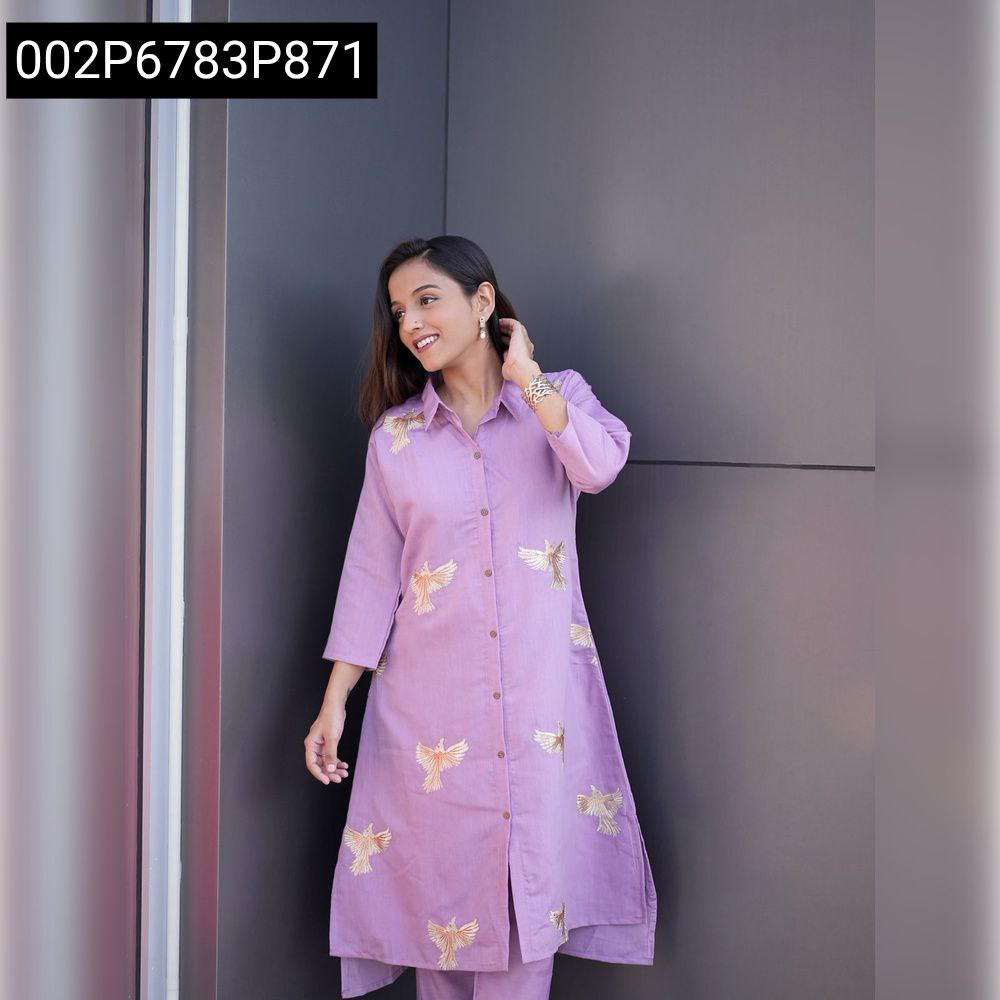 Elegant woman posing in front of a wall, wearing a lavender Roman Silk Kurta Palazzo Set with golden bird embroidery, front view.