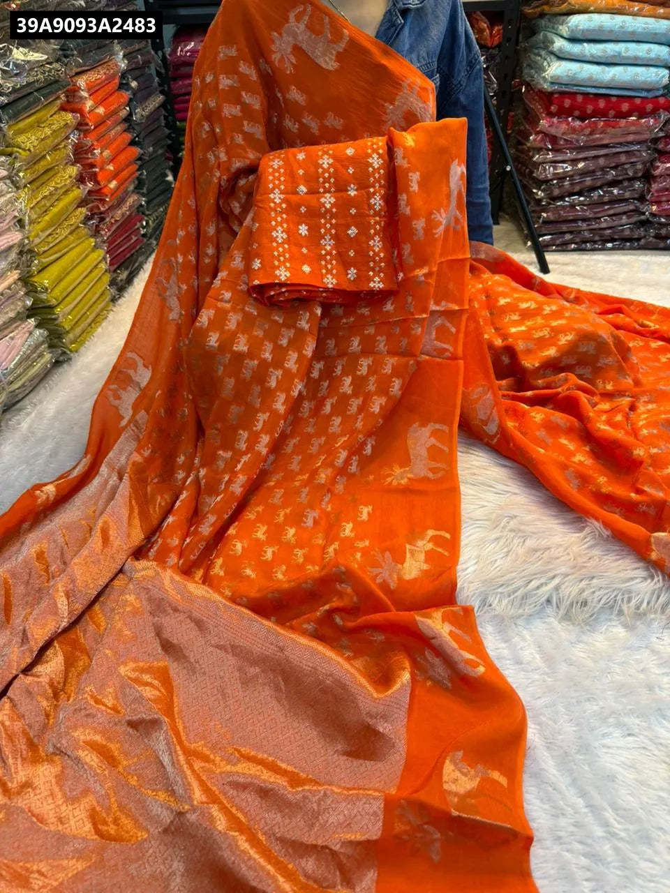 Model draped in Orange Viscose Dola Crepe Saree with deer zari border, showcasing the drape and design.