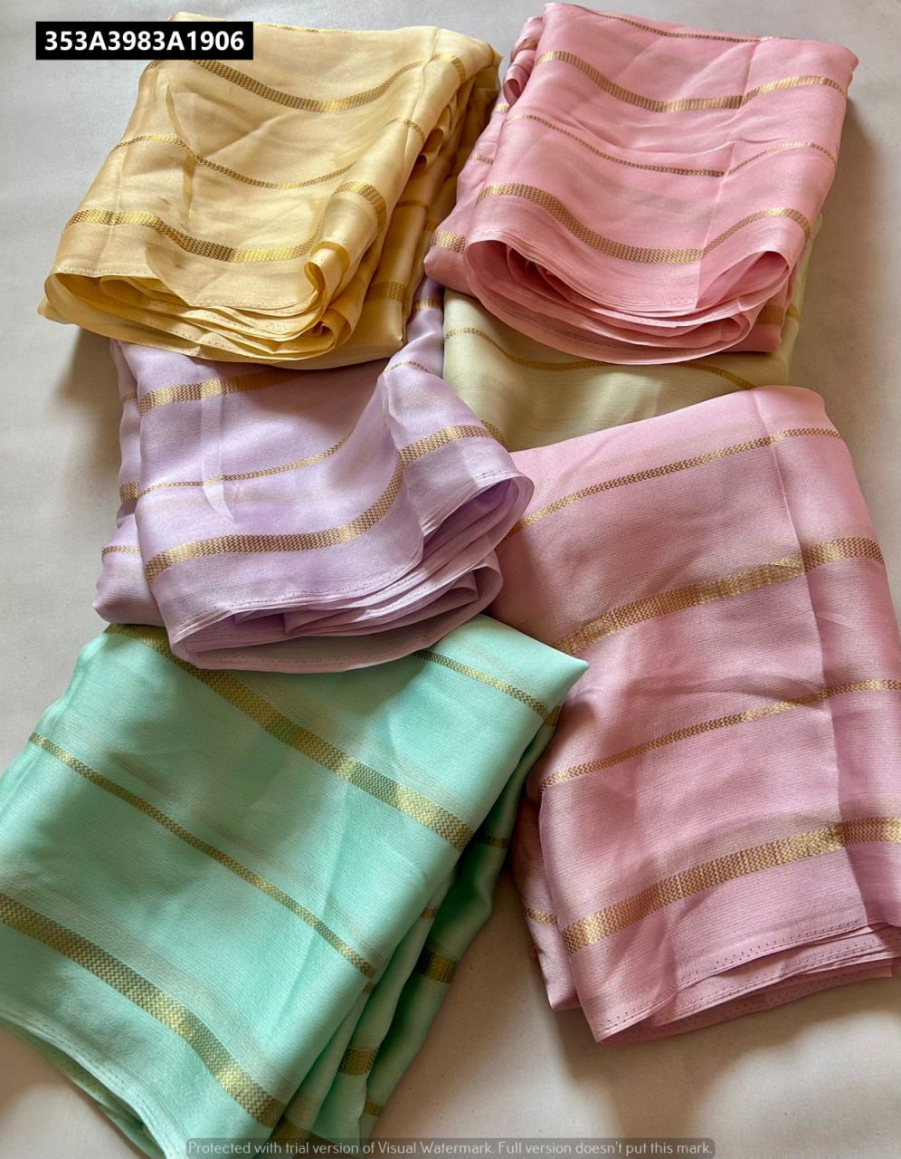 TRENDBUY Chiffon Georgette Saree collection, showing multiple pastel colors folded with gold stripe work