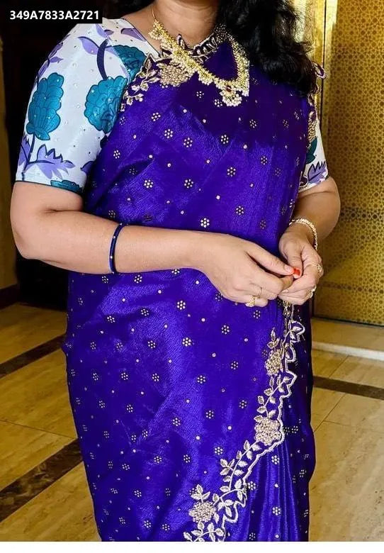Woman wearing elegant purple Chinnon silk saree with intricate Mukaish and embroidery work, showcasing the pallu and blouse design.