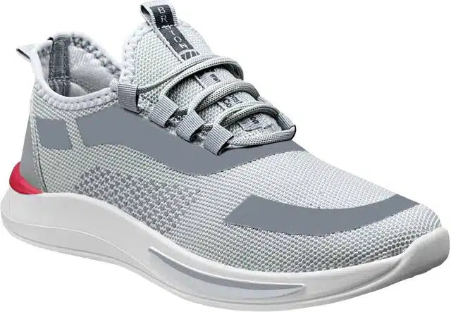 Grey sports shoes for men, side view, with laces and textured sole.