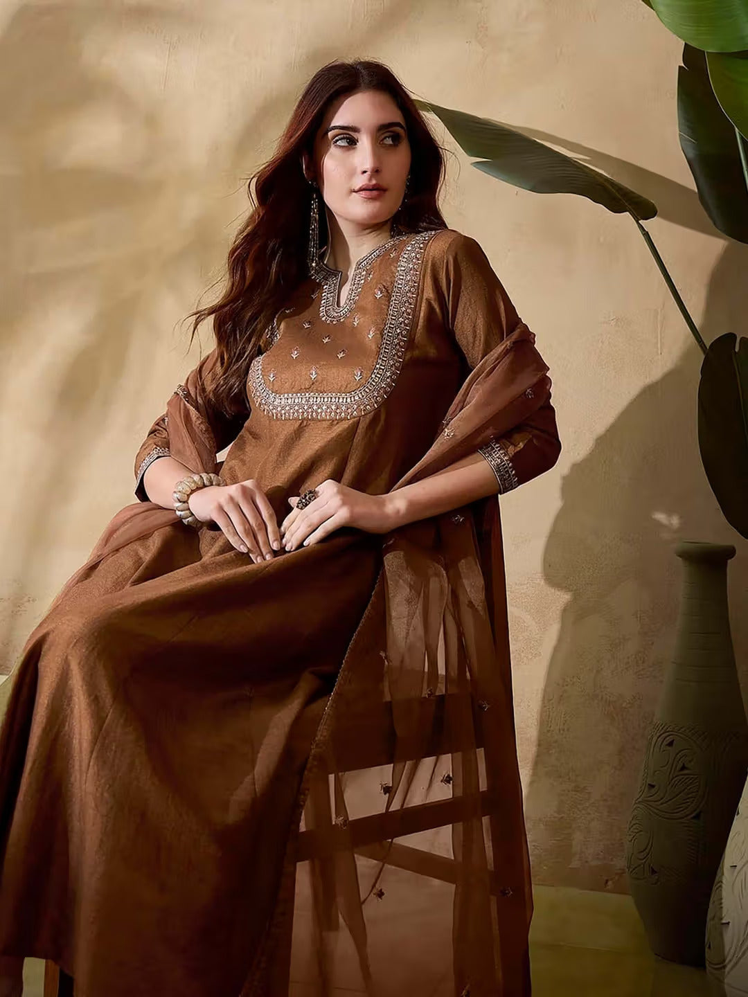 Close-up of the embroidered neckline and sleeve detail of the brown Vichitra silk kurta, with soft organza dupatta.