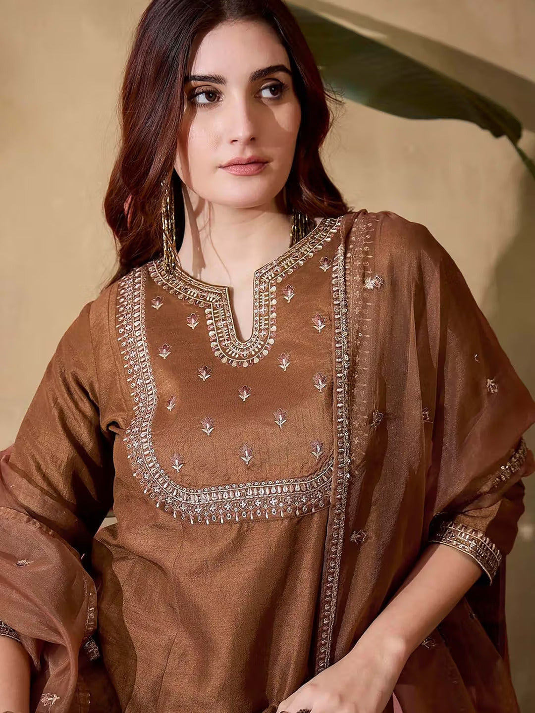 Side view of woman in brown kurta pant dupatta set, showing the ensemble's silhouette and fabric movement.