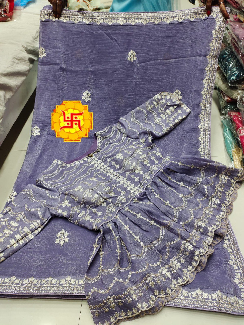 Lavender Crunchy Silk Saree with matching peplum-style blouse featuring intricate white and gold coding work and border.