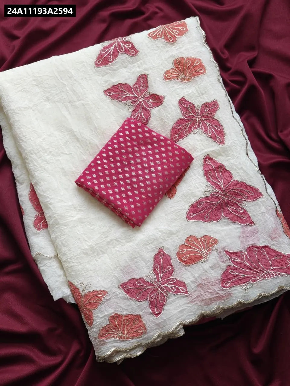 TRENDBUY Crush Chiffon Saree in off-white with pink butterfly applique embroidery and contrast pink Banarasi blouse piece, flat lay.