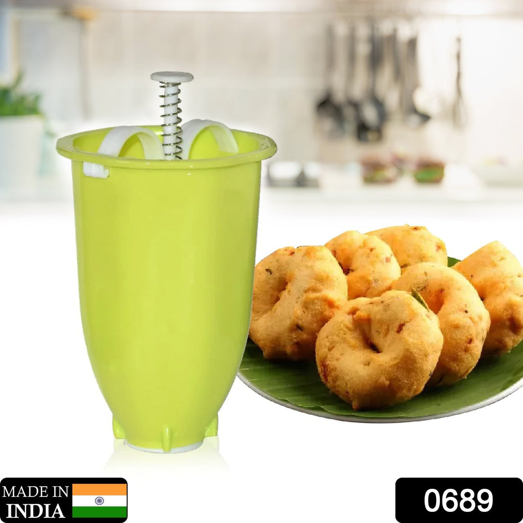 White plastic Meduwada Maker Mini Donut Maker Dispenser, held ready to dispense batter.