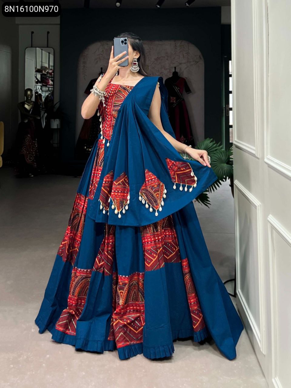 TRENDBUY Deep Blue Printed Cotton Lehenga with foil work and cowrie lace, model front facing in shop setting