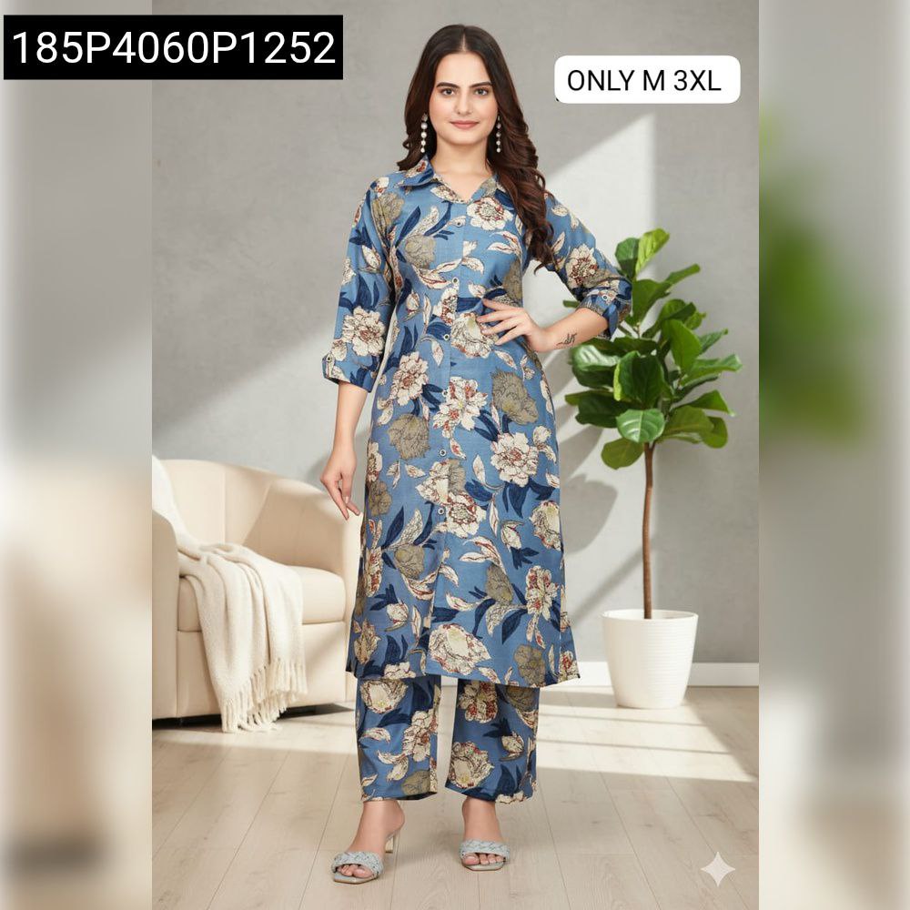 Model wearing a blue floral A-line co-ord set with ankle-length pants, standing confidently in a modern living room setting.
