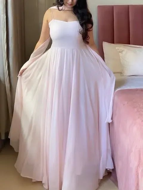 Full body front view of model wearing light pink anarkali dress indoors