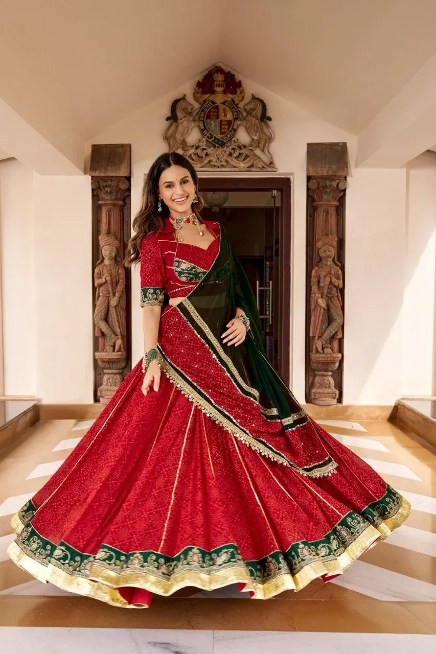 Model in red and green bandhej georgette lehenga twirling with heavy flare