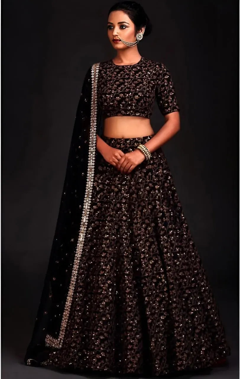 Model wearing black sequin lehenga choli with sheer dupatta