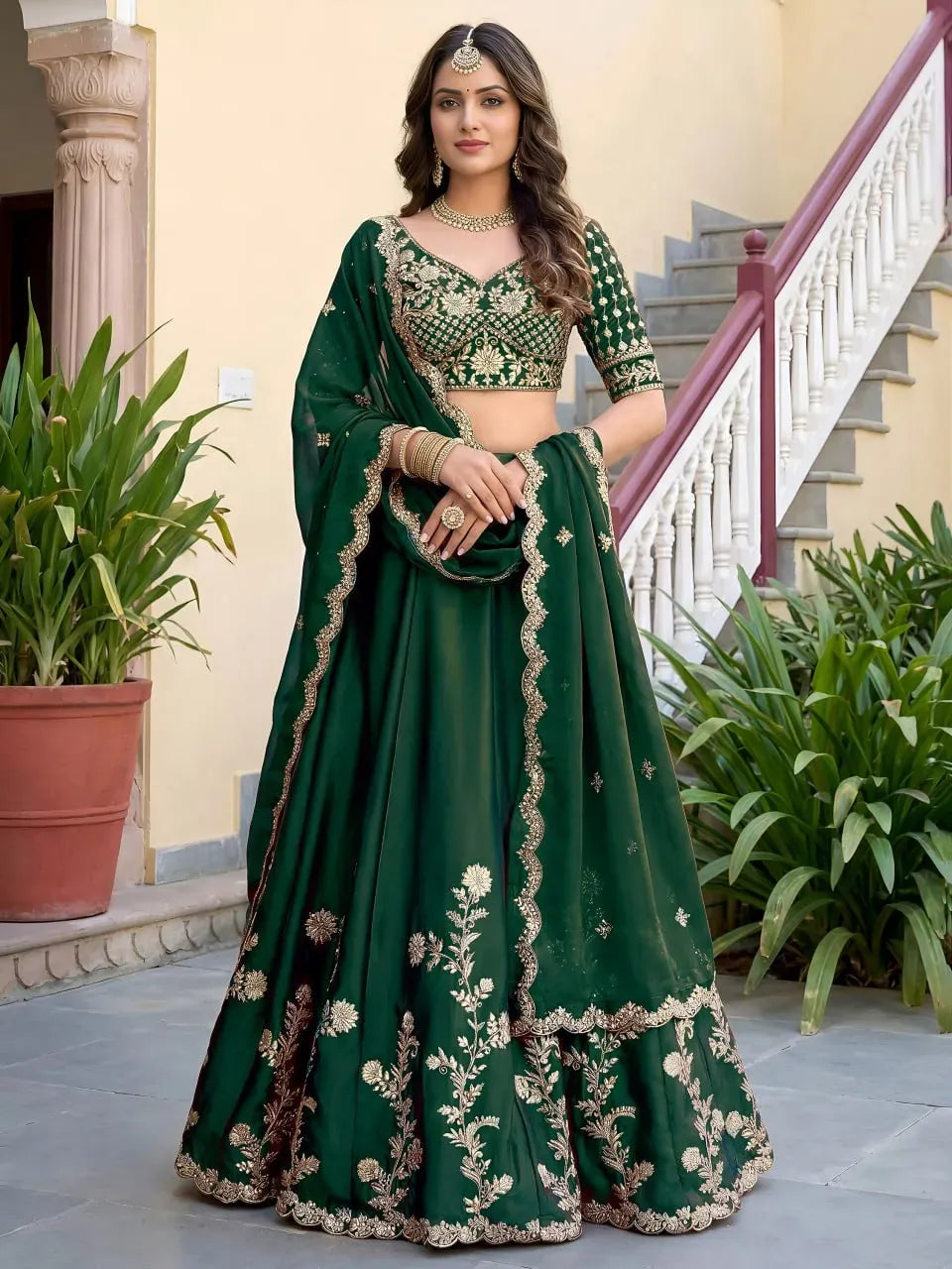Model wearing front-facing bottle green embroidered lehenga choli with dupatta