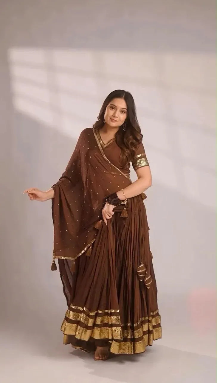 Front view of model posing in traditional brown gotta patti lehenga