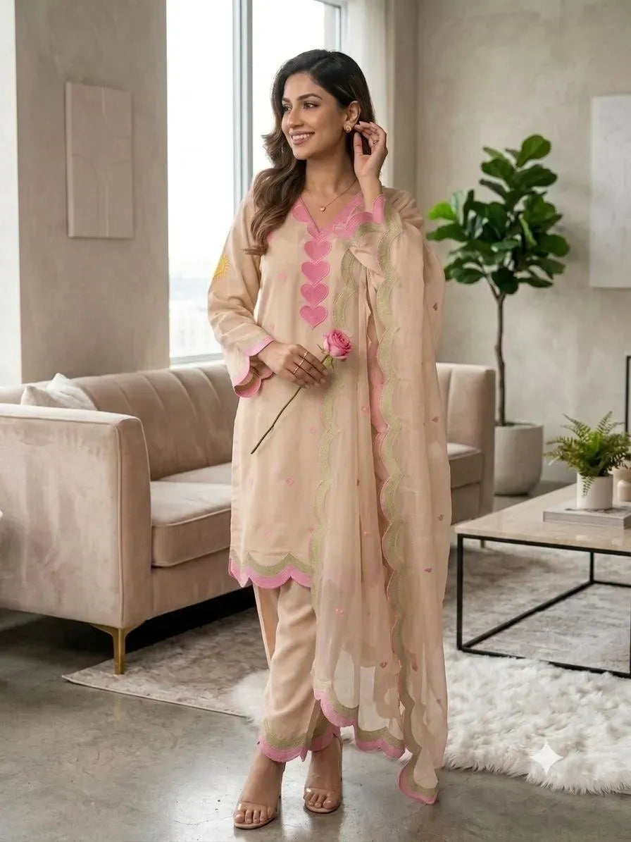Model wearing beige Chanderi salwar suit with pink embroidery and dupatta