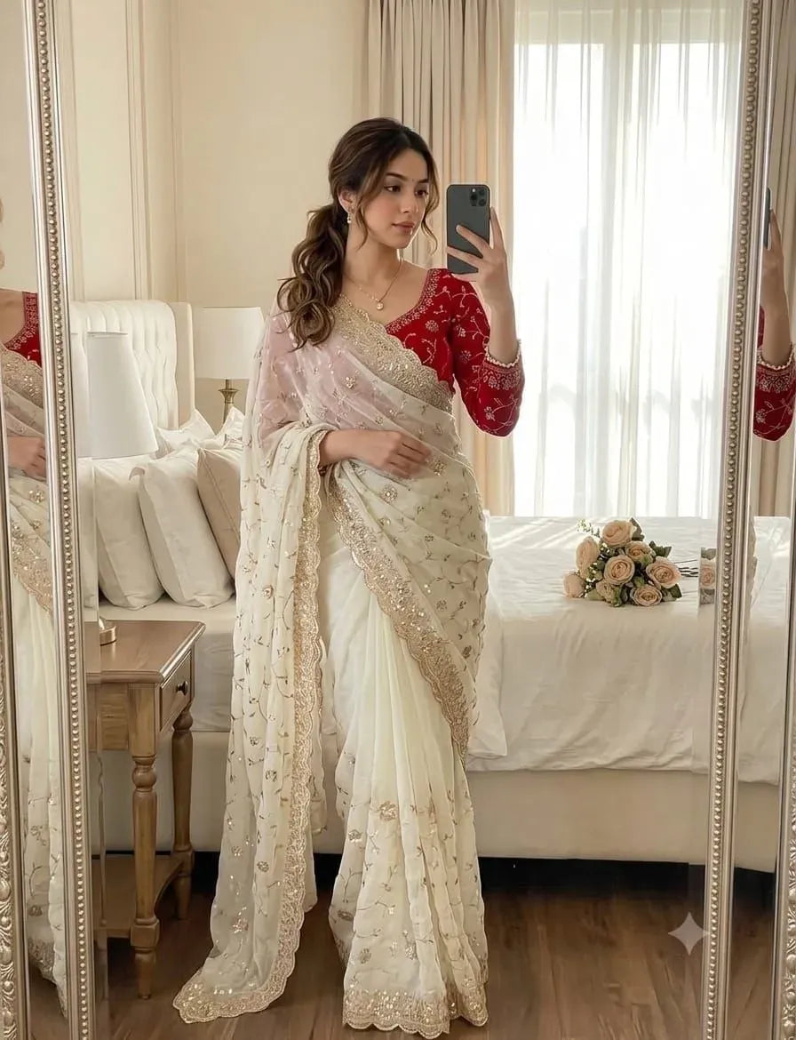 Model wearing white two-tone chiffon saree with red embroidered blouse in mirror selfie