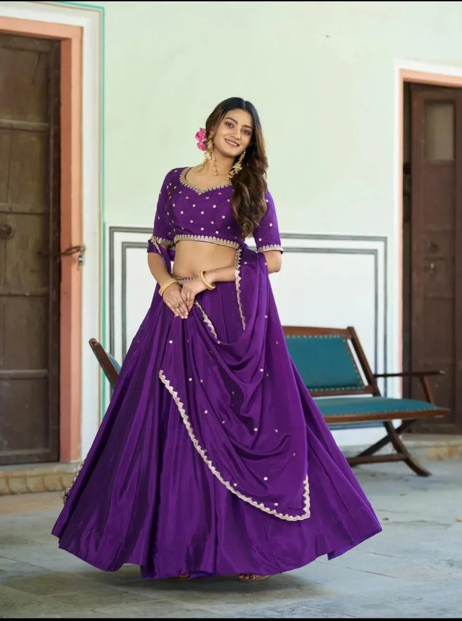 Model wearing purple chinnon silk lehenga with embroidery