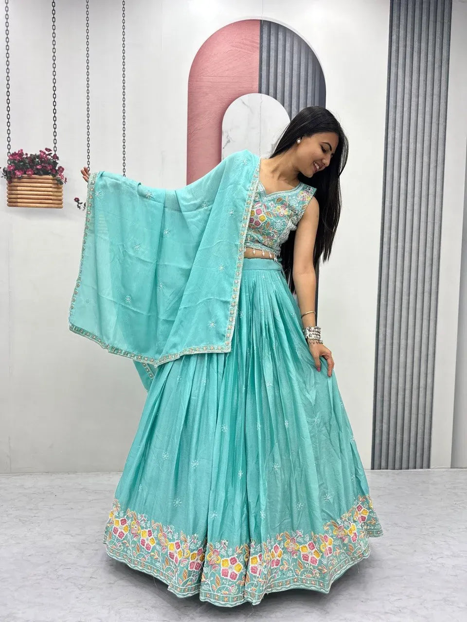 Full body shot of model in aqua blue chinon lehenga posing gracefully