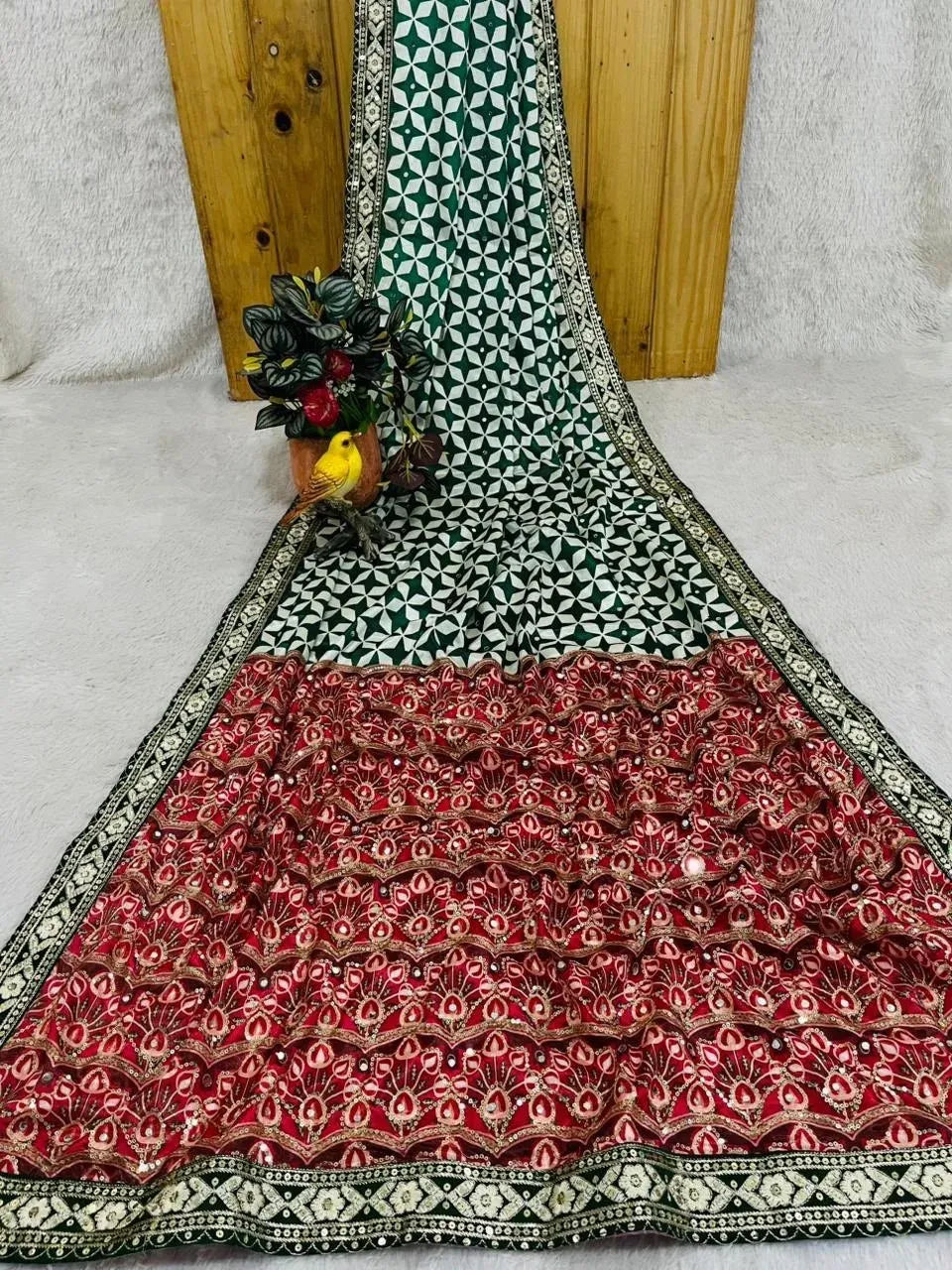 Green and white chinon silk saree draped on a wooden background