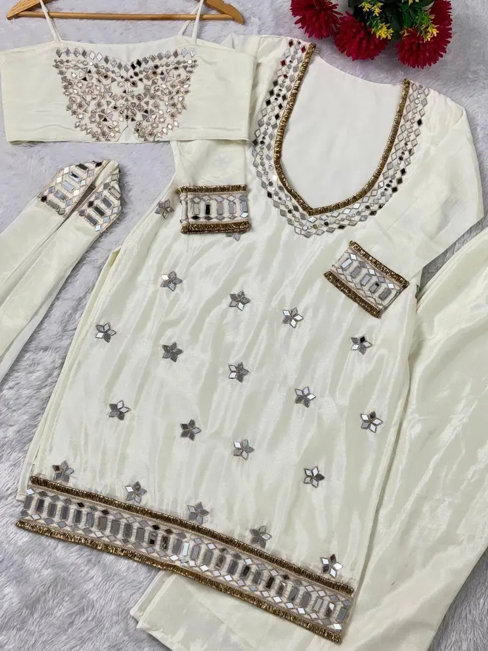 White chinon bustier, long-sleeved kurta with mirror work, palazzo, and dupatta laid flat