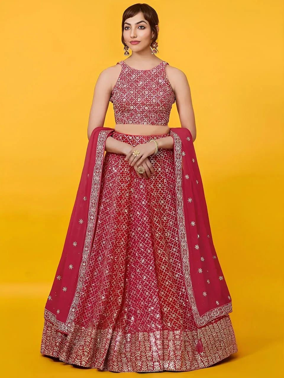 Model wearing crimson red designer lehenga choli with heavy silver sequin embroidery