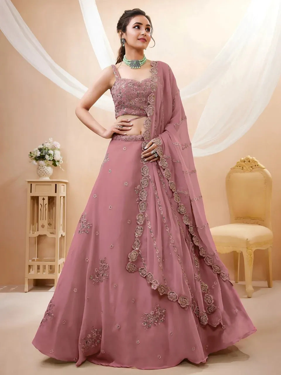 Model wearing dusty rose georgette lehenga with sequin embroidery front view