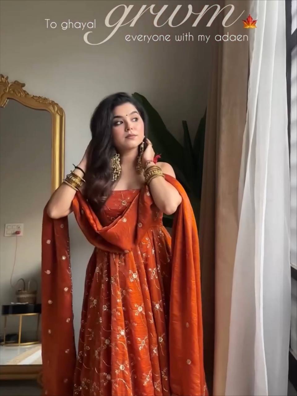 Model posing in Terracotta Orange Anarkali Suit Set with dupatta draped